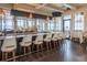 Upscale bar area with modern stools, granite countertops, and large windows at 6113 Yeats Manor Dr, Tampa, FL 33616