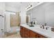 Well-lit bathroom features a tub and shower combo plus a granite-topped double sink vanity at 6113 Yeats Manor Dr, Tampa, FL 33616