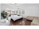 Spacious primary bedroom offering hardwood floors and bright natural light through multiple windows at 6113 Yeats Manor Dr, Tampa, FL 33616