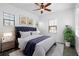 Sunlit bedroom with plush king bed, neutral colors, ceiling fan, and three large windows at 6113 Yeats Manor Dr, Tampa, FL 33616