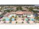 Aerial view of community clubhouse featuring swimming pools, palm trees and elegant architecture at 6113 Yeats Manor Dr, Tampa, FL 33616