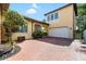 Two-story home with brick driveway, two-car garage, manicured landscaping, and mature trees at 6113 Yeats Manor Dr, Tampa, FL 33616