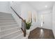 Bright foyer featuring hardwood floors, stairs with carpet and modern white trim at 6113 Yeats Manor Dr, Tampa, FL 33616