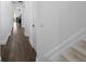 Hallway view featuring wood floors and white trim throughout the foyer at 6113 Yeats Manor Dr, Tampa, FL 33616