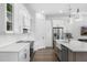 White kitchen featuring quartz countertops, stainless steel appliances, and ample cabinet space at 6113 Yeats Manor Dr, Tampa, FL 33616