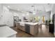 Bright, modern kitchen with stainless steel appliances and an island with a sink and white countertop at 6113 Yeats Manor Dr, Tampa, FL 33616