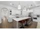Open kitchen with large island, stainless steel appliances, and modern white cabinetry at 6113 Yeats Manor Dr, Tampa, FL 33616