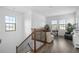 Upper floor loft space with wood floors, natural light, and an adjacent home office at 6113 Yeats Manor Dr, Tampa, FL 33616