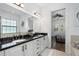 Main bathroom featuring dual sinks, a soaking tub, and an open doorway to the main bedroom at 6113 Yeats Manor Dr, Tampa, FL 33616