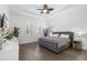 Serene main bedroom with a tufted headboard, plantation shutters, and plenty of natural light at 6113 Yeats Manor Dr, Tampa, FL 33616