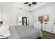 Main bedroom featuring a gray quilt, white dressers, and an ensuite bathroom at 6113 Yeats Manor Dr, Tampa, FL 33616