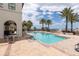 Inviting outdoor pool area with palm trees, lounge seating, and a marina view at 6113 Yeats Manor Dr, Tampa, FL 33616