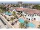 Stunning aerial view of a community pool surrounded by palm trees and lounge seating at 6113 Yeats Manor Dr, Tampa, FL 33616