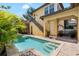 Backyard pool with stone trim and tropical plants surrounded by a backyard patio with stairs at 6113 Yeats Manor Dr, Tampa, FL 33616