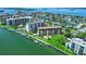Scenic aerial view of waterfront condos, boat docks, and lush green landscaping at 650 Island Way # 408, Clearwater Beach, FL 33767