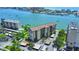 Beautiful aerial view of a waterfront condo building with manicured landscaping and ample parking at 650 Island Way # 408, Clearwater Beach, FL 33767