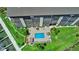 Top-down view of the building's waterfront pool and dock access with palm trees and tropical greenery at 650 Island Way # 408, Clearwater Beach, FL 33767