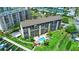 Overhead view of condos, boat docks, a tiki hut and sparkling pool on the waterfront at 650 Island Way # 408, Clearwater Beach, FL 33767