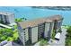 Aerial view of condo complex with beautiful water views and a sparkling pool at 650 Island Way # 408, Clearwater Beach, FL 33767