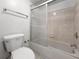 Close up of the toilet, tub, and shower with sliding glass doors and chrome fixtures at 650 Island Way # 408, Clearwater Beach, FL 33767