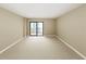 Spacious bedroom with a balcony, featuring neutral carpet and walls, perfect for relaxation at 650 Island Way # 408, Clearwater Beach, FL 33767