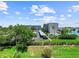 Scenic view of a condo building near a pool and waterway on a bright, sunny day at 650 Island Way # 408, Clearwater Beach, FL 33767