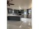A stylish kitchen boasts sleek gray cabinets, marble countertops, and stainless steel appliances at 6820 26Th W St, Bradenton, FL 34207
