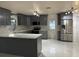 Modern kitchen featuring stainless steel appliances, gray cabinetry, and marble countertops at 6820 26Th W St, Bradenton, FL 34207