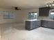 Open floor plan kitchen features gray cabinets, marble countertops, and modern stainless appliances at 6820 26Th W St, Bradenton, FL 34207