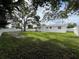 Backyard featuring mature trees and a white fence at 7536 38Th N Ave, St Petersburg, FL 33710