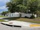 Single-story home surrounded by mature trees and a white fence at 7536 38Th N Ave, St Petersburg, FL 33710