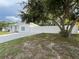 Charming single-story home with a well-manicured lawn, mature tree, and white fence at 7536 38Th N Ave, St Petersburg, FL 33710