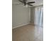 Bright bedroom featuring neutral walls, tiled floors, a ceiling fan, and vertical blinds at 8234 Ravencroft Dr, Tampa, FL 33615