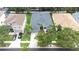 Aerial view of property in a residential neighborhood with lush lawn, mature trees, and a two-car driveway at 8814 N River Rd, Tampa, FL 33635