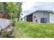 A view of a beautifully landscaped backyard with healthy grass and a well-maintained fence at 8814 N River Rd, Tampa, FL 33635