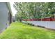 Large, well-maintained backyard with lush green grass and mature trees, offering privacy at 8814 N River Rd, Tampa, FL 33635