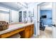 Bright bathroom with a vanity and sink, with access to both an exercise room and another bathroom at 8814 N River Rd, Tampa, FL 33635