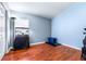 Guest bedroom with hardwood floors, large window and pet amenities at 8814 N River Rd, Tampa, FL 33635