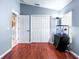 Guest bedroom with hardwood floors, large window and pet amenities at 8814 N River Rd, Tampa, FL 33635