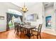 The dining room features a large table for six beneath an elegant chandelier fixture at 8814 N River Rd, Tampa, FL 33635