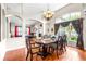 Elegant dining room boasts a large table, chandelier, and an arched window with decorative curtains at 8814 N River Rd, Tampa, FL 33635
