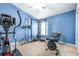 A well-equipped home gym with an elliptical trainer, a weight rack and free weights at 8814 N River Rd, Tampa, FL 33635