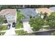 Well-maintained gray home with a two-car garage, palm trees, and a driveway at 8814 N River Rd, Tampa, FL 33635