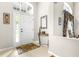 Bright foyer with a decorative rug, console table, and natural light streaming through the front door at 8814 N River Rd, Tampa, FL 33635