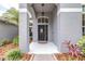 Close-up of a welcoming front door with sidelights and a covered entrance at 8814 N River Rd, Tampa, FL 33635