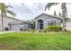 Well-maintained home with lush landscaping, a spacious lawn, and a welcoming entrance at 8814 N River Rd, Tampa, FL 33635
