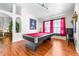 This beautiful game room is highlighted by a red billiard table and lovely wood floors at 8814 N River Rd, Tampa, FL 33635