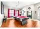Inviting game room features a red billiard table, track lighting and bright natural light at 8814 N River Rd, Tampa, FL 33635