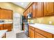 Kitchen boasting wooden cabinets, stainless steel appliances, and tile flooring at 8814 N River Rd, Tampa, FL 33635