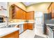 Bright kitchen featuring wooden cabinetry, stainless steel appliances, and a modern sink at 8814 N River Rd, Tampa, FL 33635